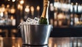 Sparkling wine bottle in ice bucket on blurred restaurant background Royalty Free Stock Photo