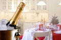 Sparkling wine bottle in ice bucket on festive kitchen background Royalty Free Stock Photo