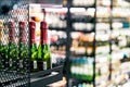 Sparkling wine on liquor store shelf. Champagne bottle on display in alcohol shop. Beverage section of supermarket.