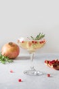 Sparkling wine, pomegranate, rosemary sprig on white table. Xmas drink Royalty Free Stock Photo