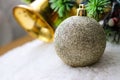 Sparkly and shiny christmas tree ornament. Golden christmas bells and christmas tree on the background. Royalty Free Stock Photo