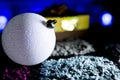 Sparkly White Christmas Ball with Gift in Colorful Background