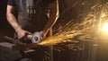 Sparks during cutting of metal angle grinder. Worker using industrial grinder.