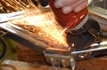 Sparks fly from a metal grinder