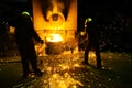 Sparks from melting steel, Men watching sparkling melting steel in furnace of foundry.