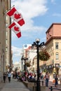 Sparks street view with walking people and canadian flags on buildings in downtown of Ottawa in Canada