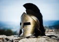 Spartan helmet on rocks. Royalty Free Stock Photo