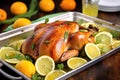 spatchcocked turkey absorbing a citrus marinade on a tray