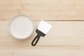 Spatula and a bucket of white putty on wooden boards. Top view Copy space Royalty Free Stock Photo