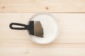 Spatula and a bucket of white putty on wooden boards. Top view Copy space Royalty Free Stock Photo