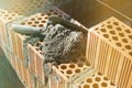 Spatula and cement mortar, red brick masonry, construction concept Royalty Free Stock Photo