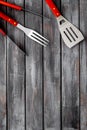 Spatula, fork, tongs for barbecue on wooden background top view mockup