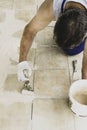 Spatula lies in a bucket with glue for tiles. worker spackles tile, selective focus Royalty Free Stock Photo