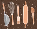 Spatula, whisk, colander, rolling pin, culinary brush on brown background.