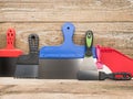 Spatulas for different jobs. Wooden background. Close-up. Royalty Free Stock Photo