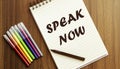 Speak Now. your future target searching, a marker, pen, three colored pencils and a notebook for writing Royalty Free Stock Photo