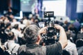 Speaker giving a talk in conference hall at business event. Rear view of unrecognizable people in audience at the Royalty Free Stock Photo