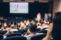 Speaker giving a talk on scientific conference. Audience at the conference hall. Business and Entrepreneurship concept. Royalty Free Stock Photo