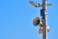 Speaker on the lighting pole. Means of warning in case of emergency. Against blue sky background copy space Royalty Free Stock Photo