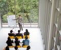 Speaker presentation in a conference meeting room with many of audiences.