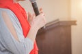 The speaker speaks with a microphone in front of a group of people