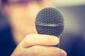 Speaking in the microphone: Young man with blurry face is taking into the microphone Royalty Free Stock Photo