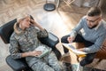 Top view of psychologist speaking with servicewoman