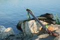 Spearfishing gear - fins, speargun on a sea rock against blue s