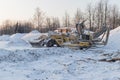 Special construction machinery on the construction site in winter season, demolition of an old building Royalty Free Stock Photo