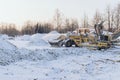 Special construction machinery on the construction site in winter season, demolition of an old building Royalty Free Stock Photo