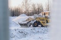 Special construction machinery on the construction site in winter season, demolition of an old building Royalty Free Stock Photo