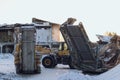 Special construction machinery on the construction site in winter season, demolition of an old building Royalty Free Stock Photo