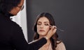 This is a special day so Im getting special treatment. a woman having her makeup done by a makeup artist. Royalty Free Stock Photo