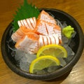 Special Deluxe salmon sashimi set on ice sever with wasabi cucumber and lemon, Maguro sashimi traditional Japanese food, closed u