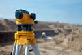 Special device level for surveyor builders, geodesy equipment close up in front of a ground work with people on blurred backgrou