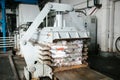 Equipment for pressing paper waste at a waste sorting plant.