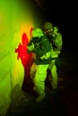 Special forces or contractor team during night mission/operation (red and green light for underline the atmosphere) Royalty Free Stock Photo