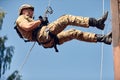 Special forces fighter descends from a skyscraper to storm the apartment. SWAT, police, counter terrorism concept. Mixed