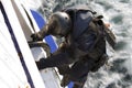 Special Forces Agent Climbing into a Moving Ship Royalty Free Stock Photo