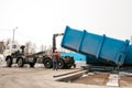 A special heavy machine loads a container with sorted waste. Royalty Free Stock Photo