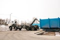A special heavy machine loads a container with sorted waste. Royalty Free Stock Photo