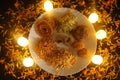 Beautiful Plate With Traditional Indian Snacks. Maharashtrian Yummy Snacks. Candles Lights and Decoration.