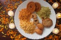 Plate With Traditional Indian Snacks. Maharashtrian Yummy Snacks. Candles Lamps and Decoration.