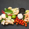 Special ingredients for popular Thai spicy soup Tom-yum kung. Lime, galangal, red chili, cherry tomato, lemongrass and kaffir lime