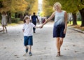 Special Kid and Loving Mom Walk Along Park Path