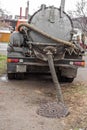 The special machine pumps out and cleans the sewer manhole from the sewer household waste