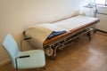 Special medical bed or couch for the examination of patients by doctor. Doctor`s office with couch on casters with disposable rol Royalty Free Stock Photo