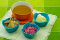 Special mixture of magenta bowls contain, onions, smashed yucca, albacore fish, ready to mix and prepare the encebollado