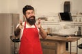 Special offer from chef. Man chef cooking. Restaurant or cafe cook. Hipster in kitchen. Mature male. Bearded happy man Royalty Free Stock Photo