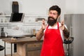 Special offer from chef. Man chef cooking. Restaurant or cafe cook. Hipster in kitchen. Mature male. Bearded happy man Royalty Free Stock Photo